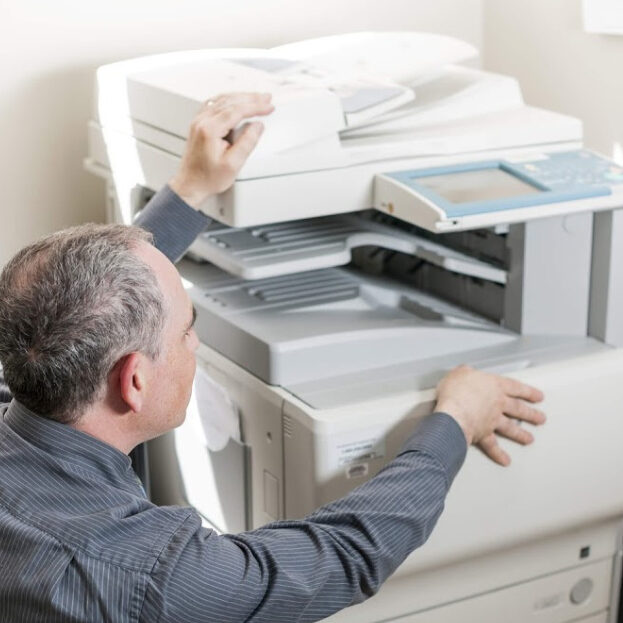 man-fixing-copier-machine