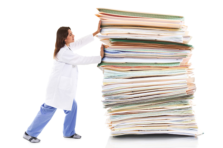 Stock image of a female healthcare worker pushing a giant stack of papers isolated on white background